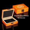 A wooden gift box with a lid open displaying a geometric design and an inner compartment for dice.