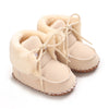 Pair of beige plush baby snow boots for girls and boys with ankle height and anti-slip soles