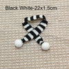 Black and white striped knit accessory measuring 22 by 1.5 cm