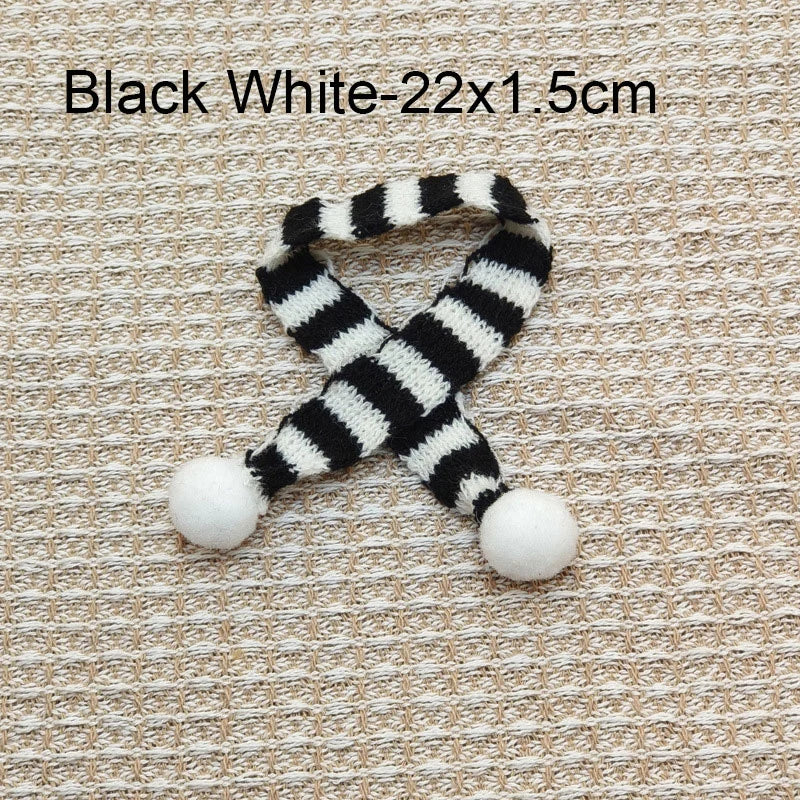 Black and white striped knit accessory measuring 22 by 1.5 cm