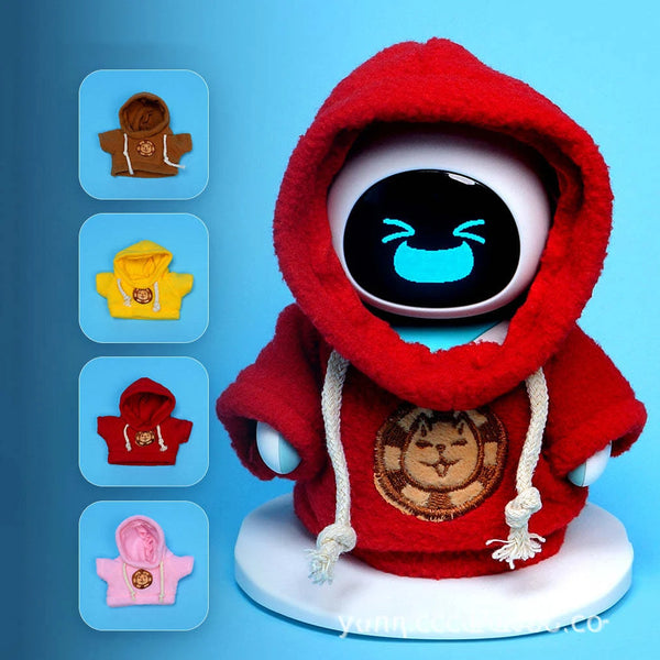 A plush toy resembling a character wearing a red hooded outfit with gold embroidery and white strings.