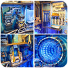 A collection of detailed wooden miniature models and puzzle bookends with blue LED lights displayed in a workshop setting.
