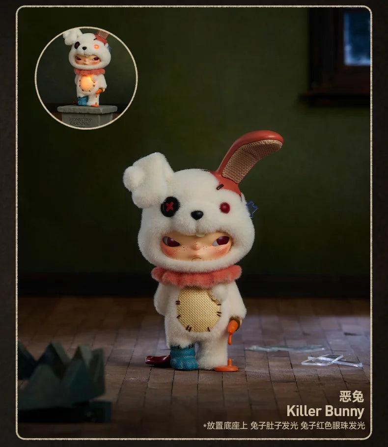 A white bunny collectible figure with pink accents and a red ear, displayed on a wooden surface.
