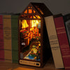 A wooden dollhouse kit featuring miniature furniture and landscape elements displayed in a dark wooden box.