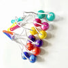 A string of colorful click clack fidget balls in shades of green, yellow, pink, and blue.