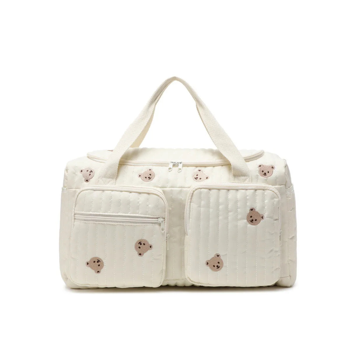 A cream-colored diaper bag with a light quilted pattern and bear embroidery.