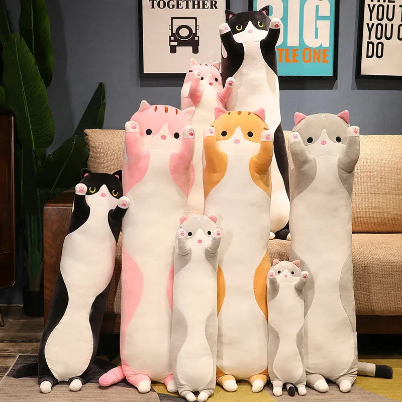 A collection of large, plush cat pillows in various colors and sizes sitting on a sofa.