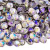 Close-up view of sparkling crystal flatback rhinestones in various shades of silver and purple.