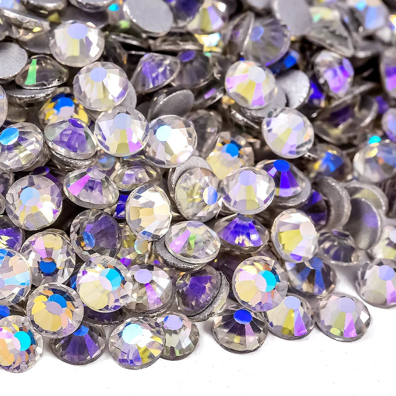 Close-up view of sparkling crystal flatback rhinestones in various shades of silver and purple.