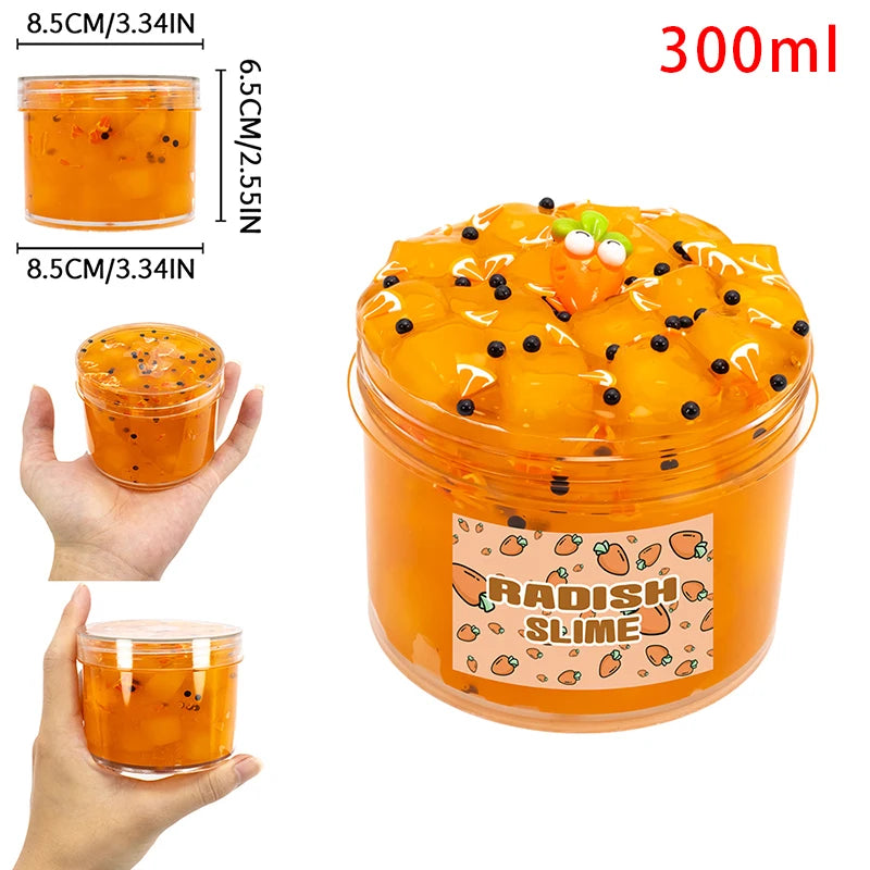 A jar of orange radish slime putty with black seeds and a carrot face decoration, showing the texture and volume.