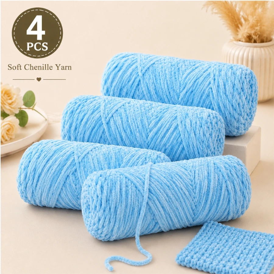 Four skeins of light blue soft chenille yarn for crochet and knitting projects.