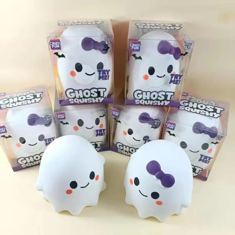 A collection of ghost squishy stress relief toys in clear packaging and loose, white ghost-shaped squishies.