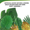 Green and gold artificial tropical palm leaves used as decorations for parties and weddings