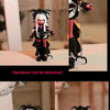 An articulated vinyl art figure of a character in black and red attire displayed in various poses.