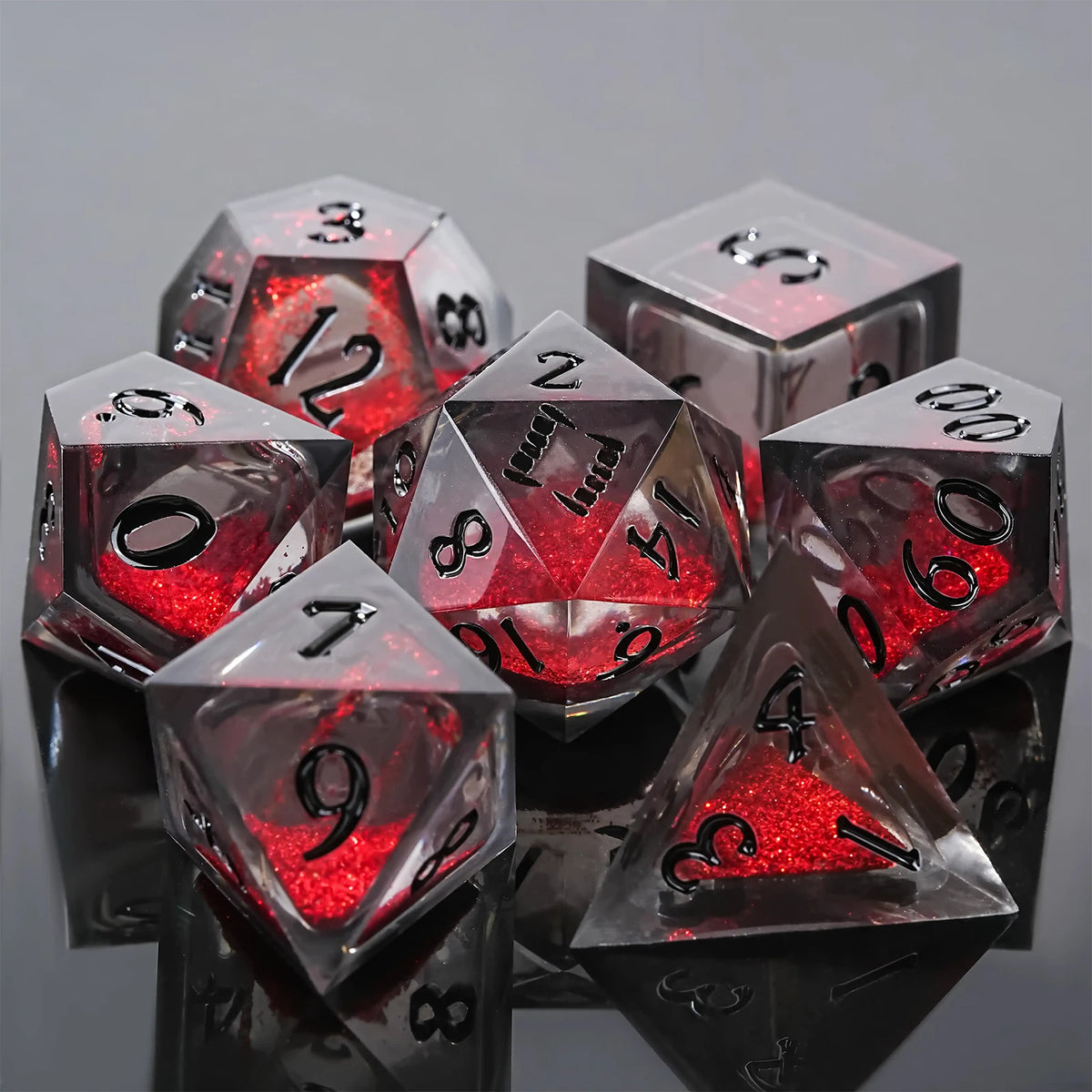 A collection of seven liquid core resin polyhedral dice in various shapes and colors.