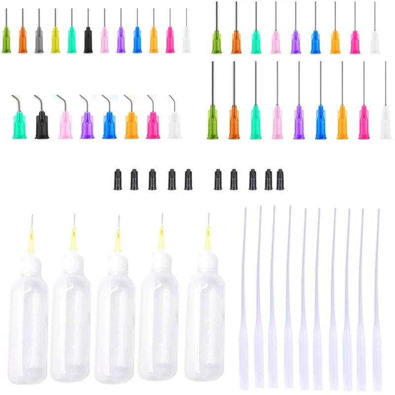 A collection of precision dispensing kit components including various colored needle tips and clear squeeze bottles.