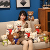 A woman sitting on a couch surrounded by several cute football bear plush toys.