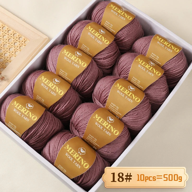 A box filled with 10 skeins of Merino wool yarn in a dusty rose color, labeled as 18# and weighing 500g.