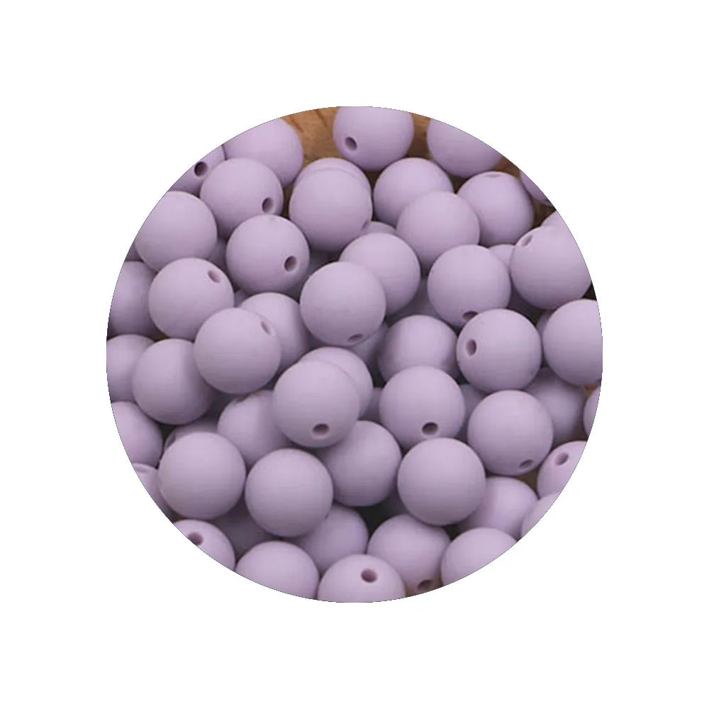 A circular arrangement of small, purple silicone beads in various sizes for DIY jewelry making.
