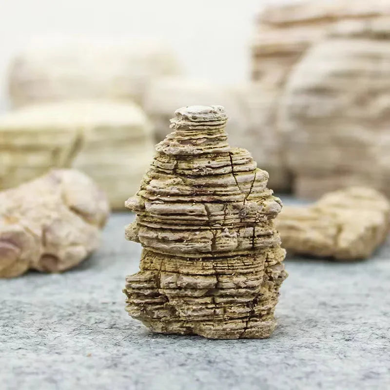 A stack of natural microporous aquarium stone for planted tanks, showing layered, textured rock.