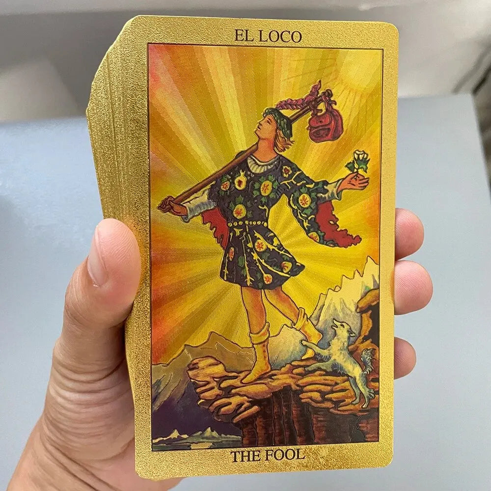A golden foil tarot card titled El Loco featuring a figure labeled The Fool against a bright yellow background.