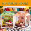 A detailed miniature house display featuring furniture and room themes for a DIY dollhouse kit.