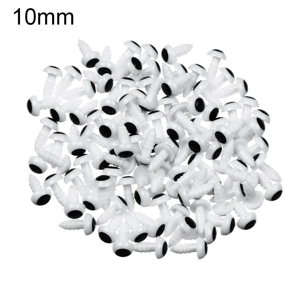A pile of small white plastic safety eyes for crafting and stuffed animals