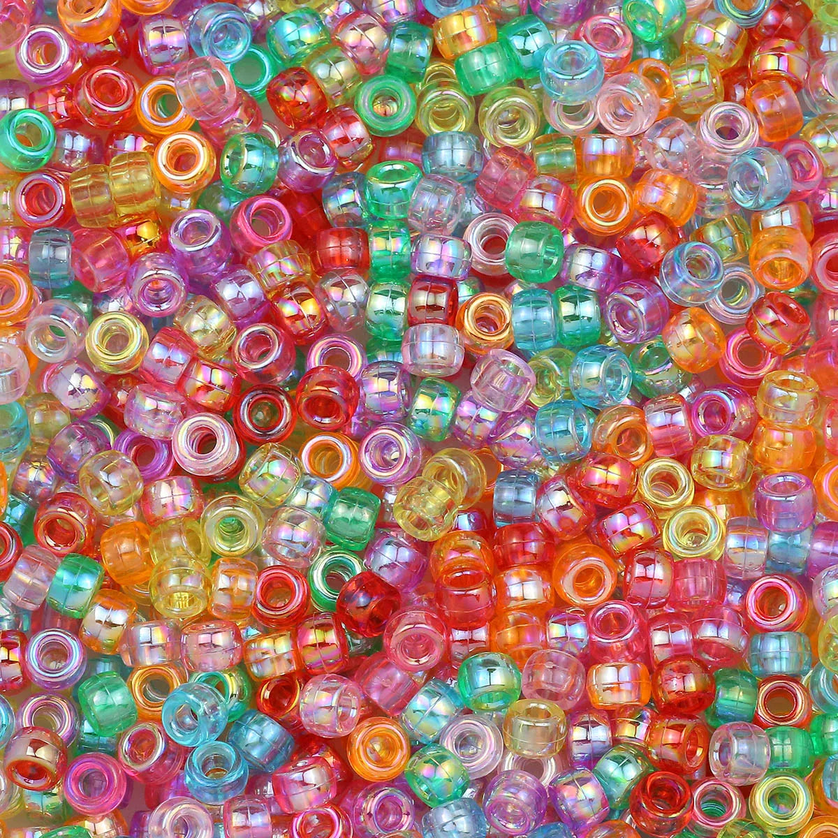 A close-up view of a pile of multicolor pony beads in various shades of pink, orange, green, and blue.