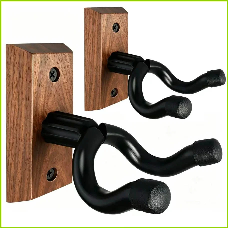 A set of dark wood guitar wall mounts with black curved hangers for securing musical instruments.