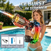 A woman holds a multi-colored LED electric water gun, demonstrating its ice burst feature in a backyard setting.