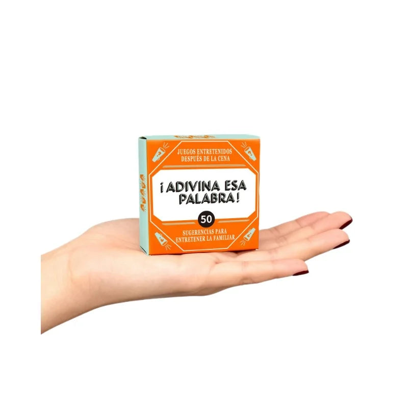 A hand holds a box of a Spanish word guessing game with 50 cards for adults and teens.