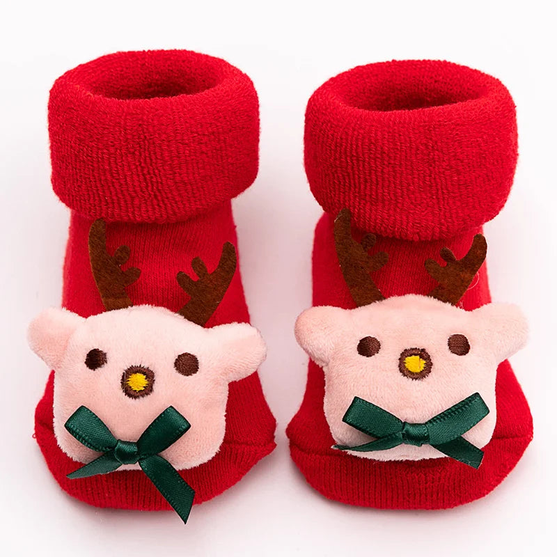 Pair of red baby anti-slip cotton socks with festive Christmas designs.