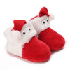 A pair of adorable animal-themed baby first walker shoes resembling Santa boots with white fur and red accents.