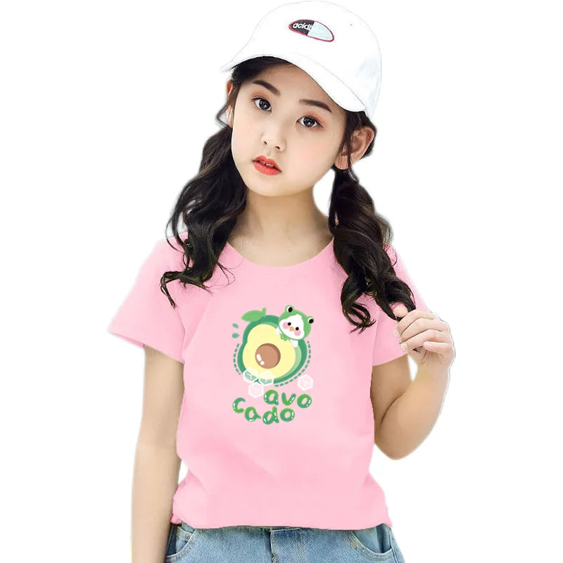 A young woman models a pink t-shirt featuring an avocado and lemon graphic print.