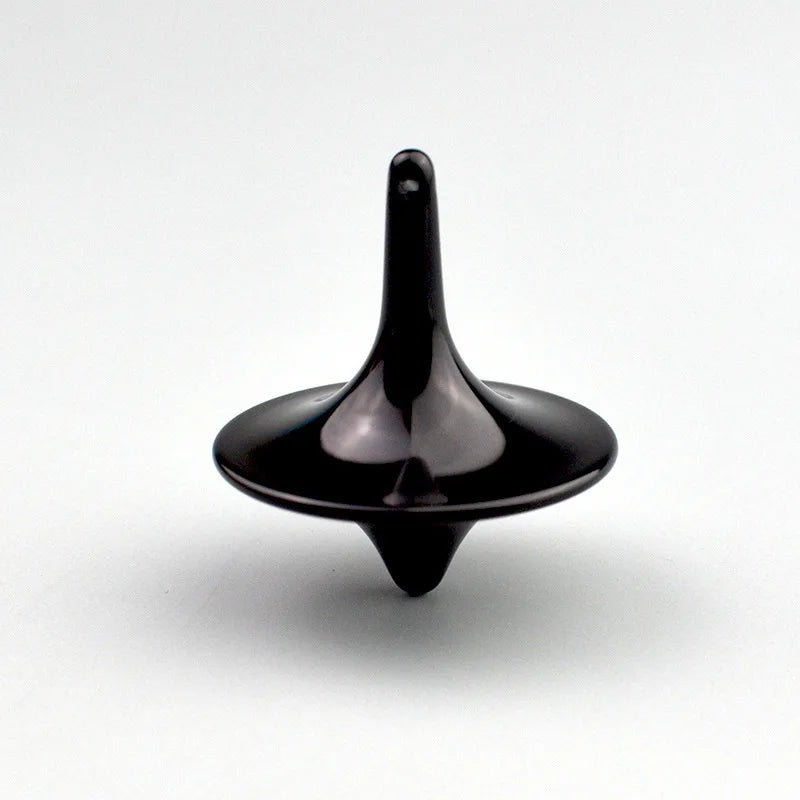 A black metal fidget spinner with a smooth, tapered design.