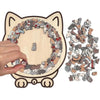 A wooden jigsaw puzzle featuring many cats arranged in a circular pattern, with some pieces scattered beside it.