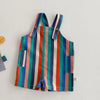 Colorful striped kids overalls featuring vertical stripes in blue, orange, pink, and green.