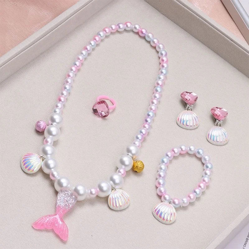 A set of five mermaid pearl jewelry pieces including a necklace, earrings, and bracelets in pink and white pearls.