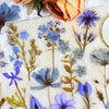 A collection of floral PET stickers featuring blue, purple, and yellow flowers on a light background.