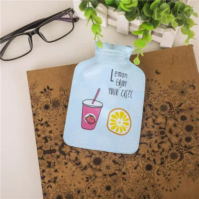 A clear plastic bottle with a light blue tint and a green leafy decoration is placed on brown paper.