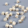 A collection of ten white and black six-sided dice scattered on a gray surface.
