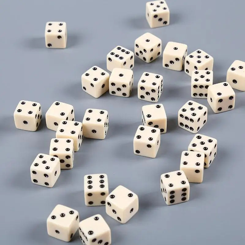 A collection of ten white and black six-sided dice scattered on a gray surface.