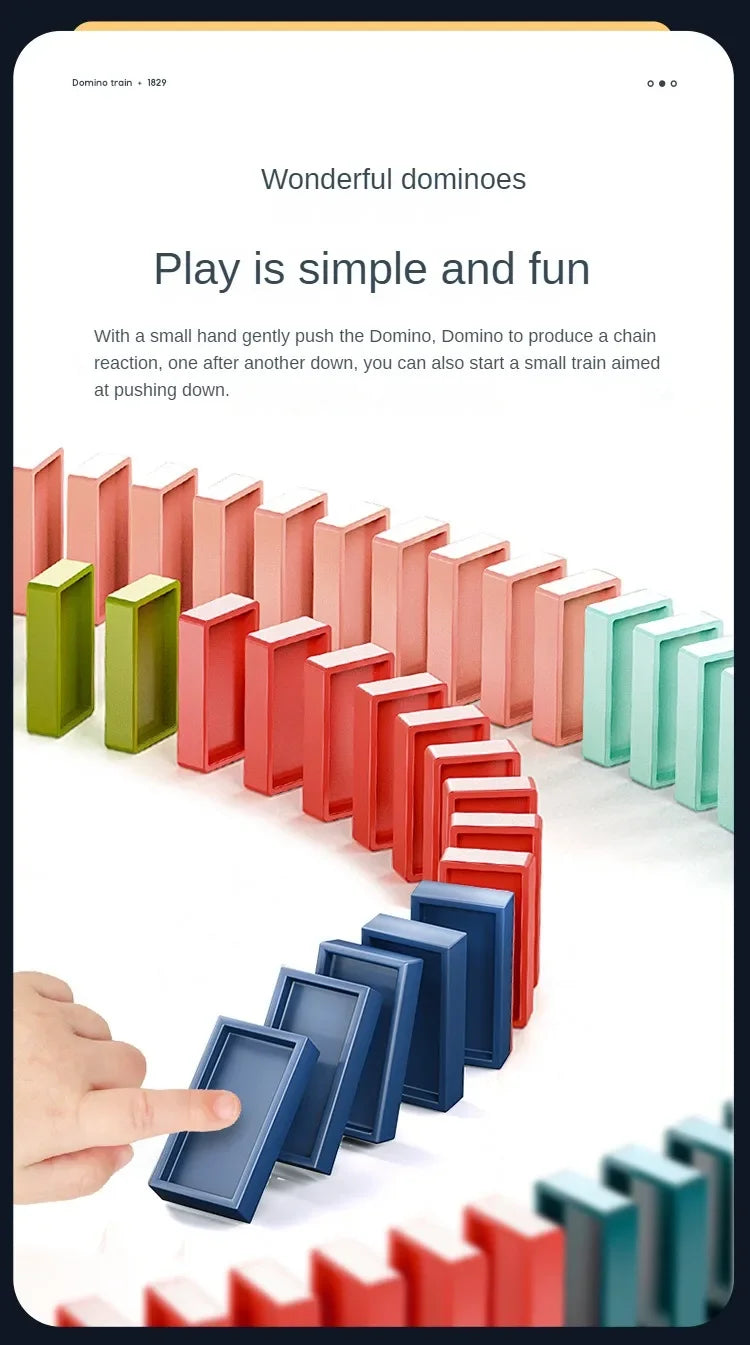 A hand is pushing a train of colorful domino blocks across a white surface.