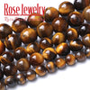 A close-up of natural yellow tiger eye stone beads used for jewelry making.
