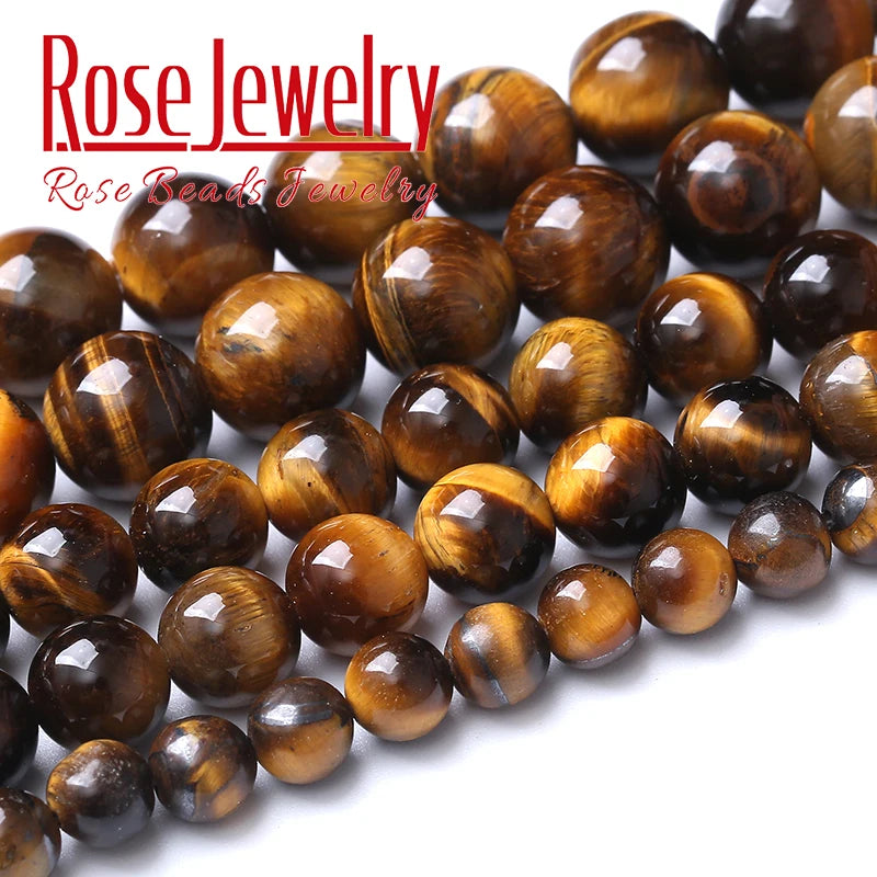 A close-up of natural yellow tiger eye stone beads used for jewelry making.