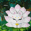 A white building block set of a nine-tailed fox character with pink accents, displayed in a forest setting.