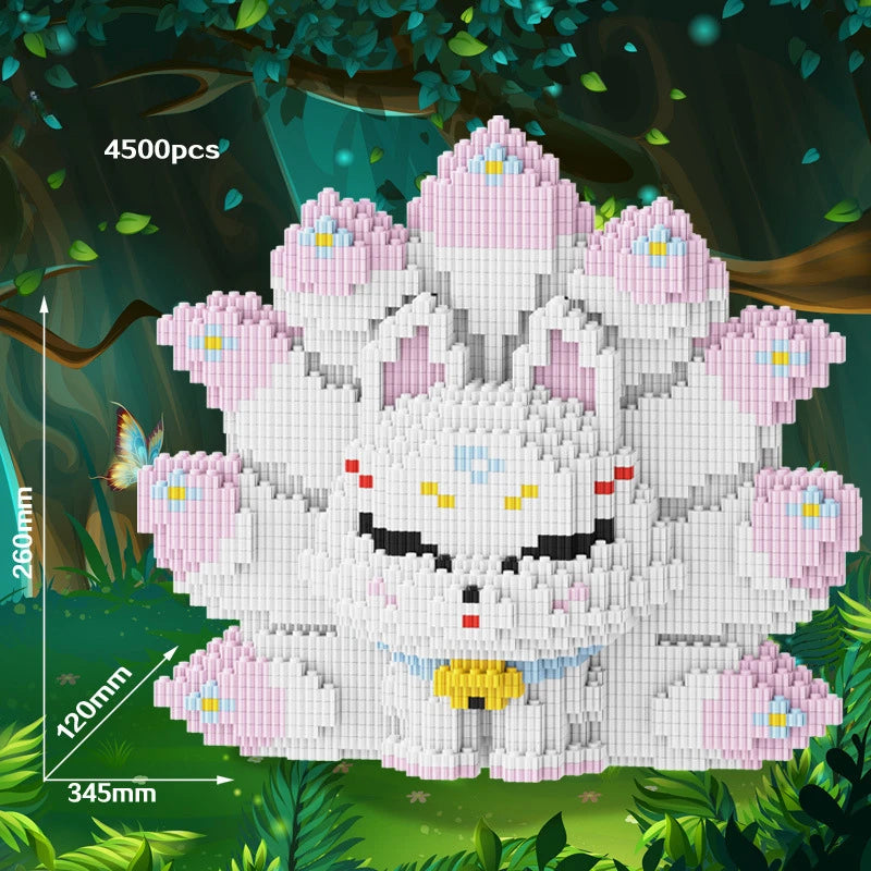 A white building block set of a nine-tailed fox character with pink accents, displayed in a forest setting.