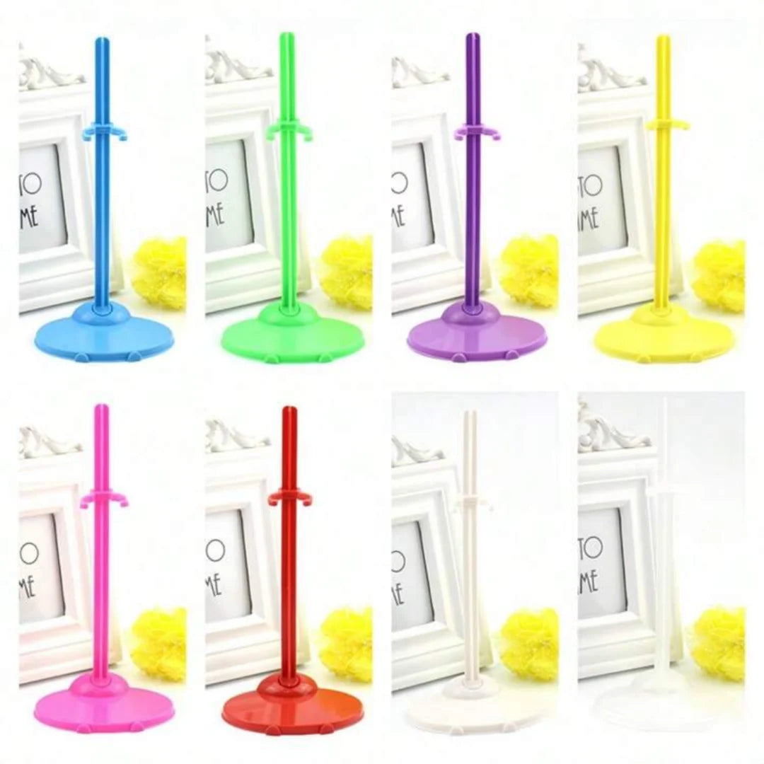 A collection of transparent doll display stands with waist clips in various colors including blue, green, purple, yellow, and