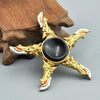 A gold-colored metal fidget spinner featuring a star design with rainbow accents and a black center.