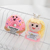 Handmade crochet donut doll with pink icing and gold crown wearing a positive message
